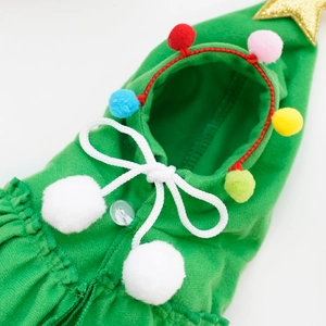 Christmas pet cape in green fabric with colorful pom-poms and gold star detail for dogs