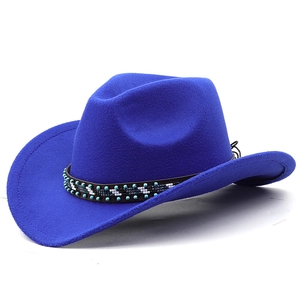 Detail of royal blue felt cowboy hat with ethnic beaded band on a white background