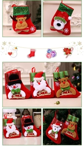 Detail of red velvet Christmas stockings with embroidered reindeer and festive motifs