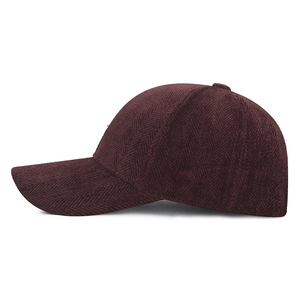 Classic wine red herringbone baseball cap with a structured brim shown from a side view
