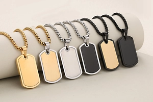 Detailed display of six rectangle dog tag pendants in assorted metallic finishes and box chains