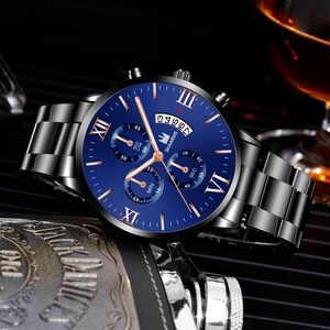 Macro detail of men's business watch with blue dial, Roman numerals and steel strap