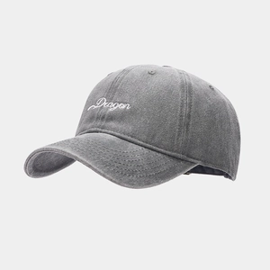 Close-up of a dark grey washed cotton baseball cap with white Dragon embroidery