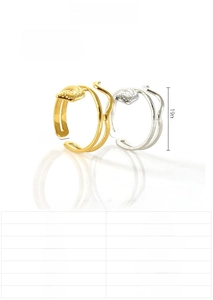 Macro view of 18K gold and silver snake skin textured rings with detailed star pattern