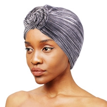 Detailed close-up of silver-gray elastic braided turban hat with textured wavy fabric