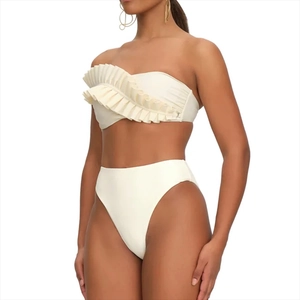 Detailed view of ivory white ruffled bandeau swimsuit with high-waisted bottoms and pleats