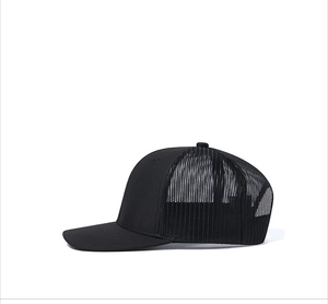 Side view of black mesh truck cap featuring a curved brim and breathable fabric panels