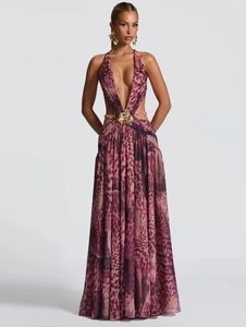 Macro detail of sexy leopard print maxi dress with deep V-neck and gold flower buckle
