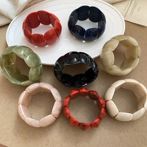 Macro shot of colorful acrylic geometric bracelets with elegant marble texture pattern