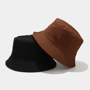 Close-up of black and brown cotton bucket hats showing durable canvas texture and stitching