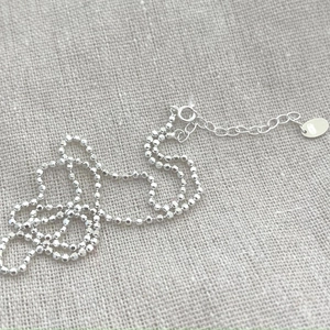 Minimalist 925 sterling silver faceted bead chain necklace with lobster clasp on burlap