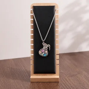 Bamboo wood necklace display stand featuring gemstone pendants and bead jewelry chains