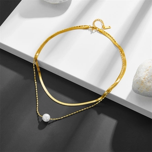 Double-layered stainless steel necklace featuring a gold flat snake chain and white pearl pendant