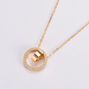 Close-up of golden dual-ring pendant necklace with sparkling white rhinestone embellishments