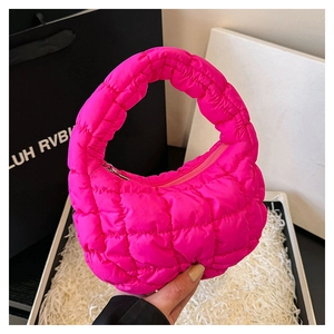 Macro shot of fluorescent pink quilted mini cloud bag with fluffy texture and handle