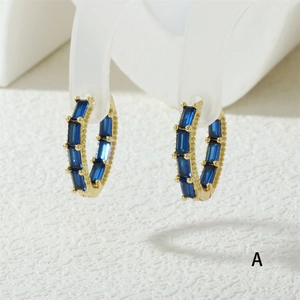 Macro shot of 18K gold-plated hoop earrings with deep blue rectangular zircon stones