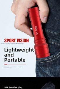 Mini red LED flashlight being placed into a jeans pocket showing its compact portable size