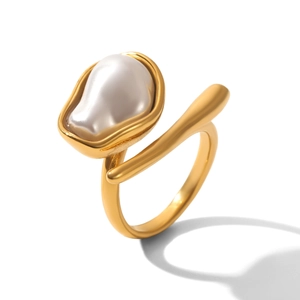 Close-up of golden irregular baroque pearl on a matte finish stainless steel ring