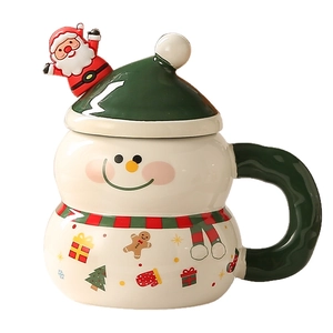 Christmas snowman ceramic mug with green lid and festive patterns on a white background