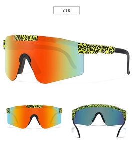 Detail view of large sports sunglasses with neon leopard pattern and colorful mirror lenses