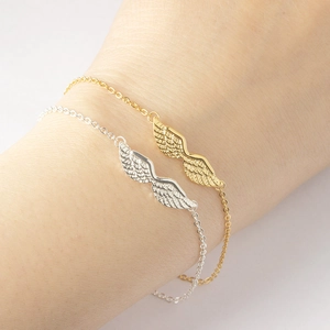 Elegant angel wing charm bracelets in gold and silver finish for women on wrist