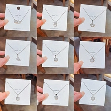 Detailed grid of nine assorted luxury bear and heart pendant necklaces on cards