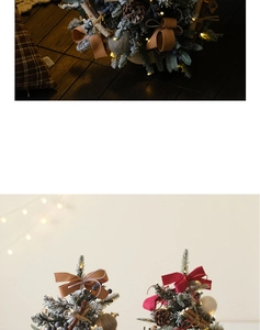Mini Christmas tree with red bows, pine cones, and warm LED lights in a cozy setup