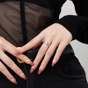 Close-up of S925 sterling silver heart ring with sparkling zircons on a model's finger