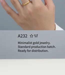 Detail of minimalist gold teardrop stud earring with intricate woven texture on finger