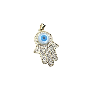 Hamsa Hand pendant with sparkling crystals and Evil Eye detail on white background