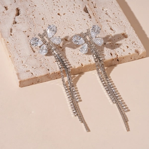 Close-up of silver butterfly tassel earrings with sparkling zircon fringe details