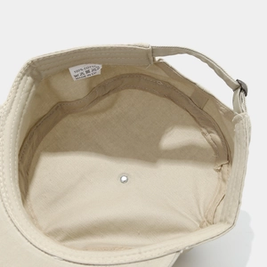 Close-up of internal details showing 100% cotton tag and stitching on flat top cap