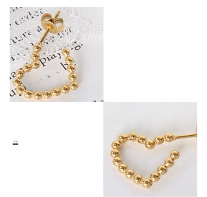 Detail of beaded heart stud earring crafted in 18K gold plated titanium steel material
