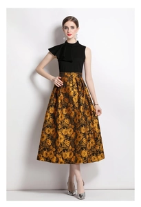Detailed view of the intricate floral jacquard fabric on a gold sleeveless dress