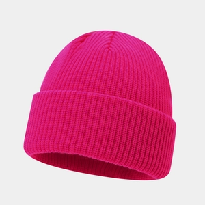 Close-up of bright pink rib-knit texture and folded cuff on a winter beanie hat