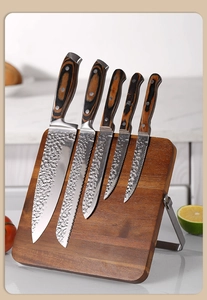 Close-up of hammer-patterned stainless steel knives on double-sided magnetic wood block