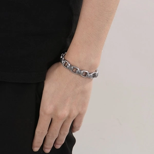 Close-up of vintage stainless steel bracelet with engraved floral patterns on wrist