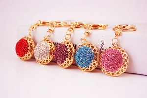 Detailed row of crystal-studded ball keychains in red, white, purple, blue, and pink