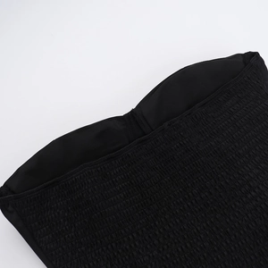 Detail shot of black smocking embroidery on strapless dress with elastic pleated texture