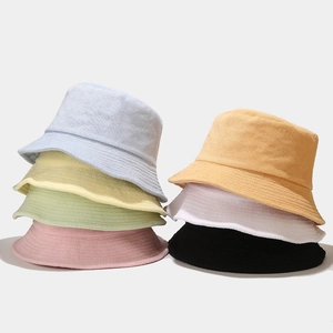 Multi-color bucket hats in textured terry cloth fabric, shown in a balanced vertical stack