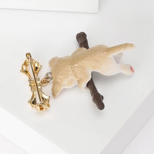 Cute Corgi dog brooch featuring a cartoon dog hanging on a brown branch with gold pin