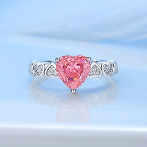 S925 silver heart-shaped pink gemstone ring with white side stones on blue background