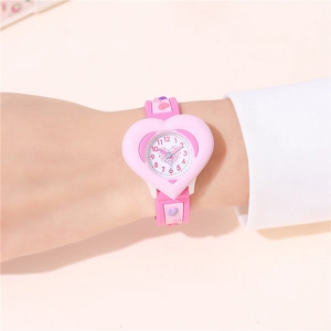Pink heart-shaped children's watch with analog display worn on a wrist for kids