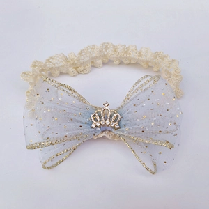 Detail of baby headband with blue mesh bow, lace band and gold crown rhinestone