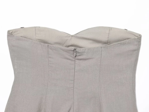 Detail of grey linen-blend strapless top featuring a seamless invisible back zipper closure