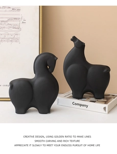 Close-up of matte black abstract ceramic horse statues in a modern home decor setting