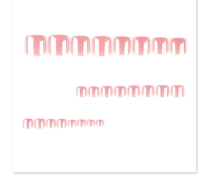 Macro detail of glossy nude pink square press-on toenails in a neat matrix layout