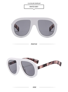 Detail of white oversized pilot sunglasses with grey lenses and tortoiseshell temples
