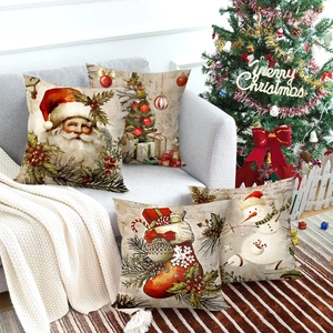 Set of 4 vintage Christmas pillow covers with Santa and reindeer on a cozy gray sofa