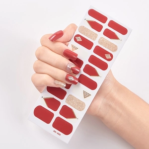 Detailed view of red and gold glitter self-adhesive nail stickers with geometric patterns